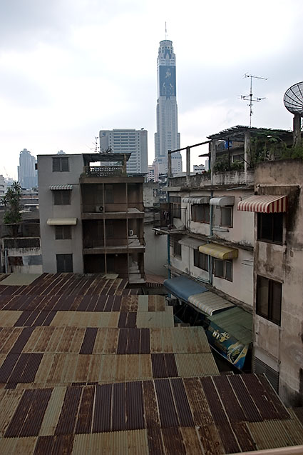 Poor housing in the foreground and the Baiyoke Skytower in the background