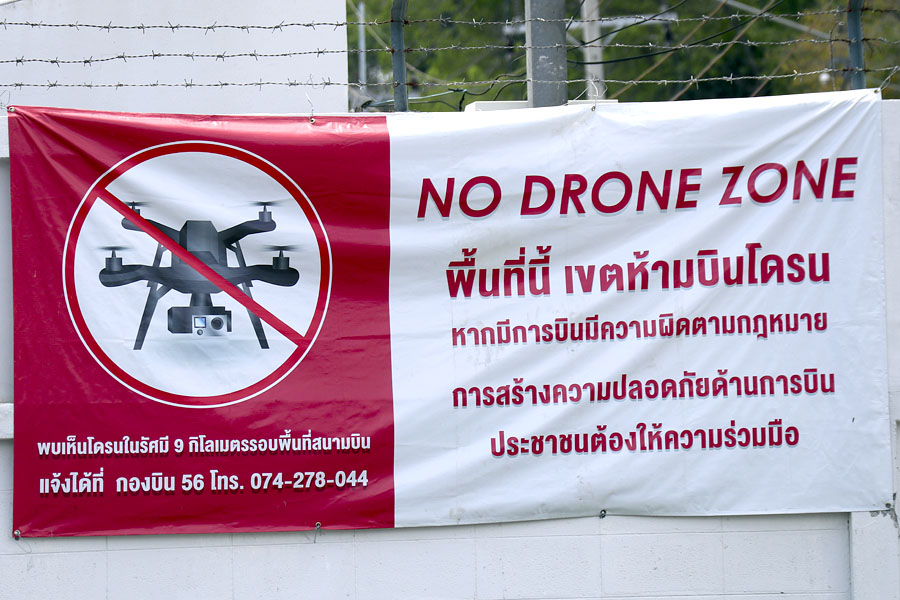 This sign is near both a commercial airport and a Royal Thai Air Force base