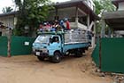 Trucks full of labourers arrive each morning as reconstruction gets underway but it is a huge job - Click for larger image