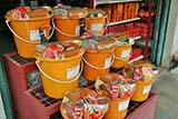 Buckets of goodies can be bought to give to monks - Click for larger image