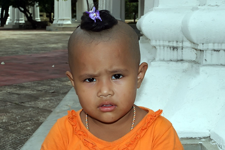 Young Thai boy with a traditional topknot at Nakhon Pathom, Thailand
