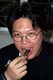 Eating a fried grasshopper - Click for larger image